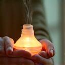 Person using aromatherapy or essential oils with soft lighting, symbolizing stress reduction techniques.